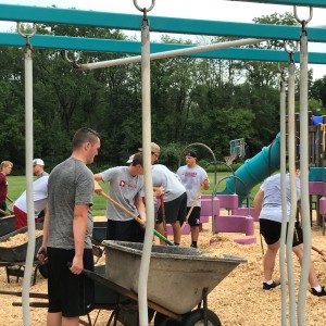 The SJF football players worked hard on mulching the playground.